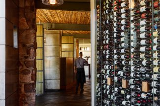 Elements wine wall with server walking past.