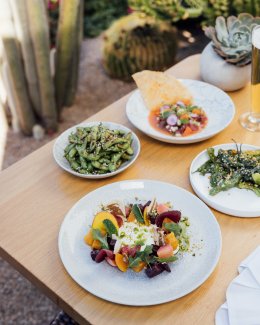 A collection of summer dishes served outside on Sanctuary's Paradise Views Patio.