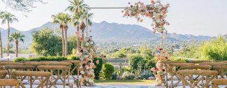 Ceremony on Paradise Views patio with scenic mountain backdrop.