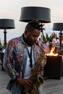 Man playing saxophone at The Firepit.