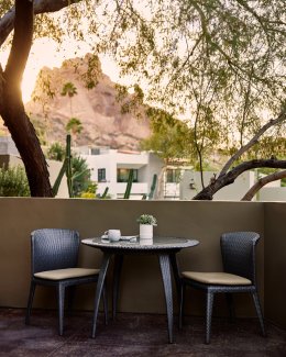 Spa Casita patio seating area with coffee cup and stunning sunset view of Praying Monk.