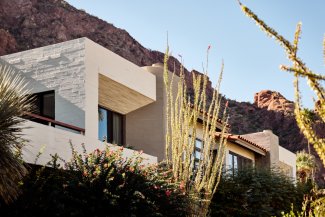Exterior of Mountain Casitas and Suites nestled into lush desert landscape.