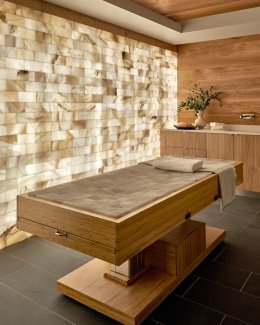 Treatment room with wood finishes and accent wall.