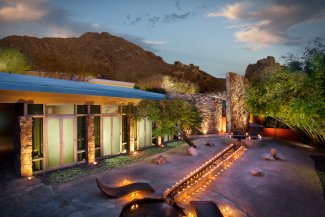 Overhead view of Sanctuary Spa's Zen Garden lit with candles at dusk.