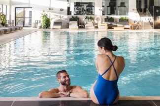 Couple relaxing in the indoor saltwater pool at Gurney's Seawater Spa.