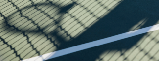 A silhouette of a person holding a tennis racquet 