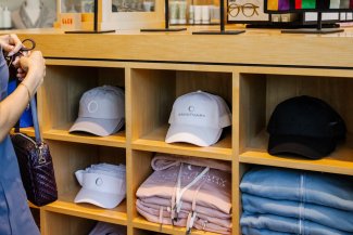 Close up of hats and clothes with Sanctuary and Gurney's branding in Scottsdale's retail shop.