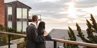 A couple in robes overlooks the view at Gurney's Montauk Resort