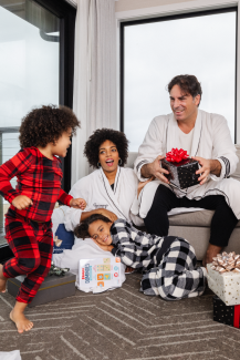 A family in pajamas opens presents at Gurney's Montauk Resort