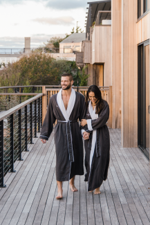 A couple in robes walks the spa deck at Gurney's Montauk Resort