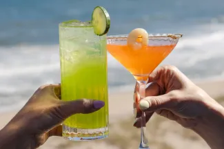Cheercing two drinks on the beach