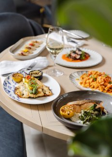 This is a table full of plates of food. 